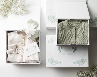Trio of Isla & Fraser gift boxes containing baby knitwear