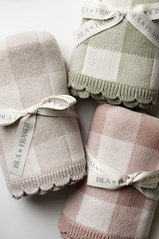 sage green Isla & Fraser baby blankets tied with a cream ribbon