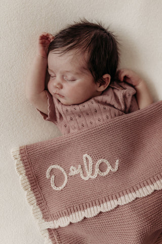Personalised baby blankets with hand embroidered names tied with ribbons