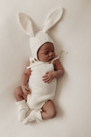Baby wearing knitted bunny bonnet