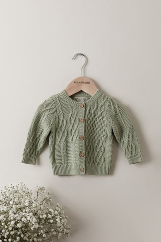 Sage green cable knit baby cardigan on Isla & Fraser hanger 