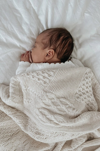 Sleeping Baby with dummy and knitted blanket