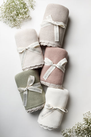 Stack of Isla & Fraser knitted scallop edge baby blankets