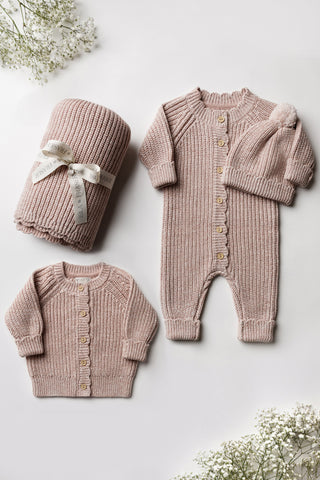 Pink knitted baby blanket, cardigan, romper, and hat