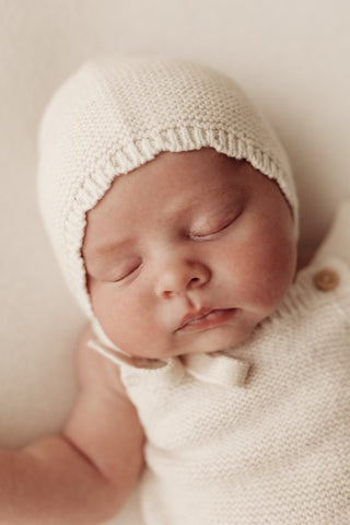 Baby wearing knitted bonnet