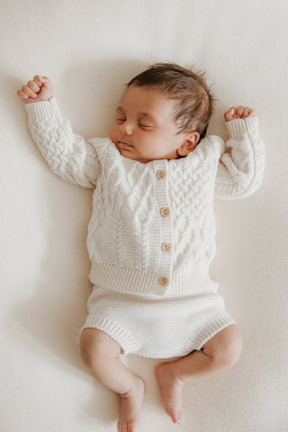 Sleeping Baby in Knitted Cardigan and Bloomers 