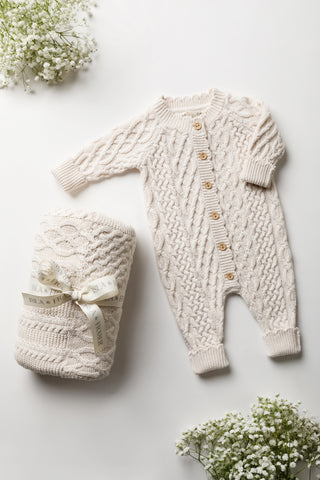 Knitted baby blanket and romper gift set in cable knit