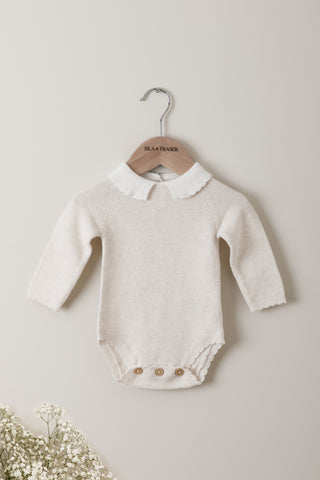 Knitted Baby Bodysuit with Collar on a wooden Isla & Fraser hanger