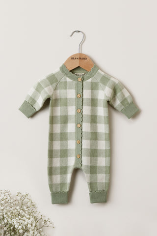 Knitted Sage Green Baby Romper on a wooden Isla & Fraser hanger