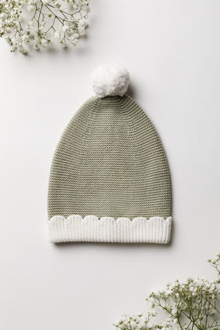 Knitted Sage Green Baby Hat with white pom pom and scalloped edge