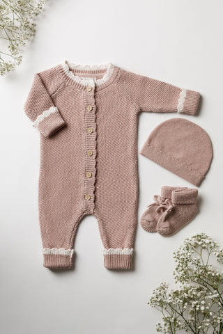 Pink knitted baby romper. hat. and booties