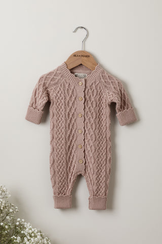 Cable knit baby romper in pink on Isla & Fraser hanger